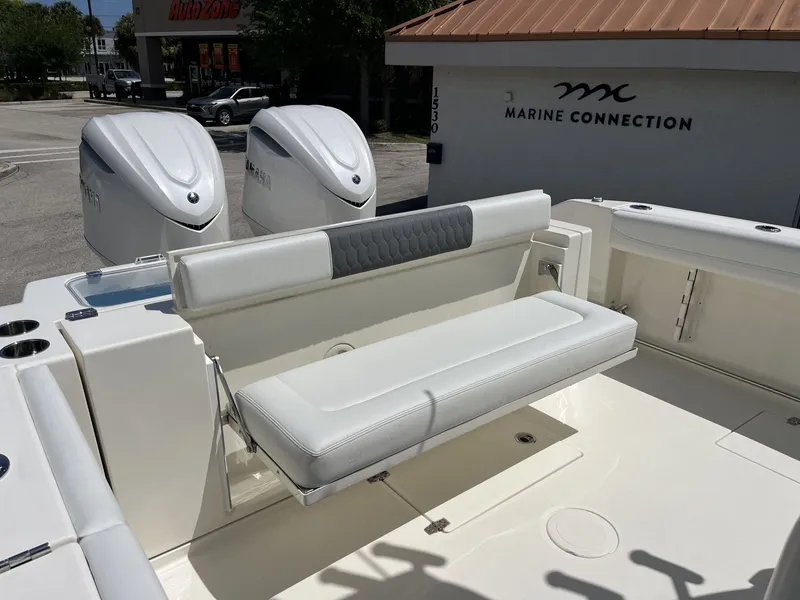 Slide: The Image of 2026 Cobia 320 Center Console with dual engines and seating area. - 35