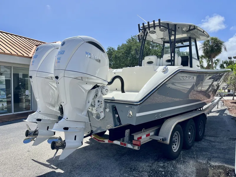 Slide: The Image of 2026 Cobia 320 Center Console with Yamaha engines on trailer. - 6