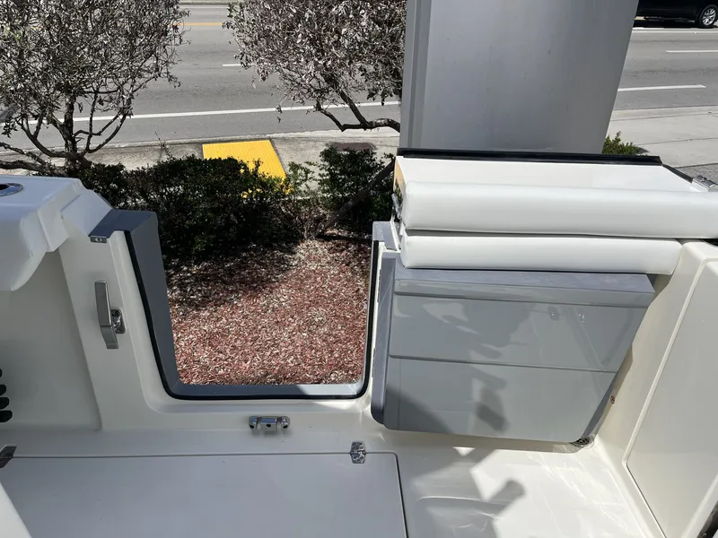 Slide: The Image of Cobia 320 Center Console 2026 with open door and seating area. - 33