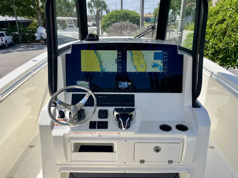 Slide: The Image of Cobia 320 Center Console 2026 helm with navigation screens. - 13