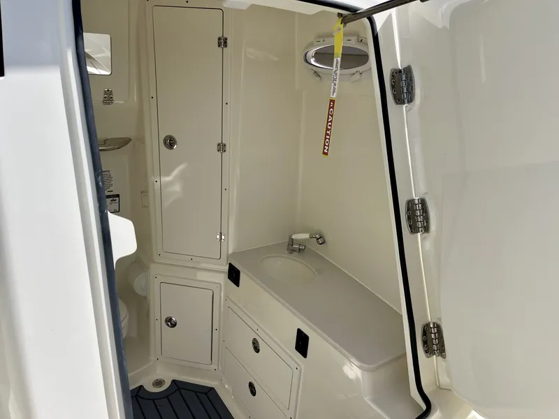 Slide: The Image of Interior of 2026 Cobia 320 Center Console with sink and storage. - 24
