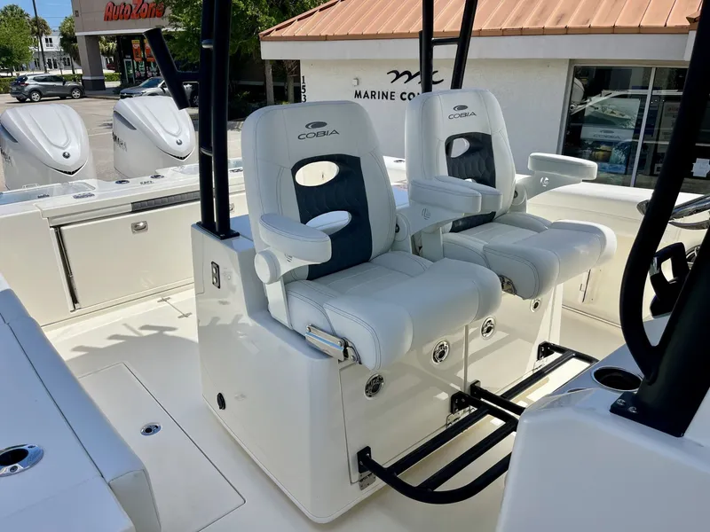 Slide: The Image of 2026 Cobia 320 Center Console with luxurious seating. - 27