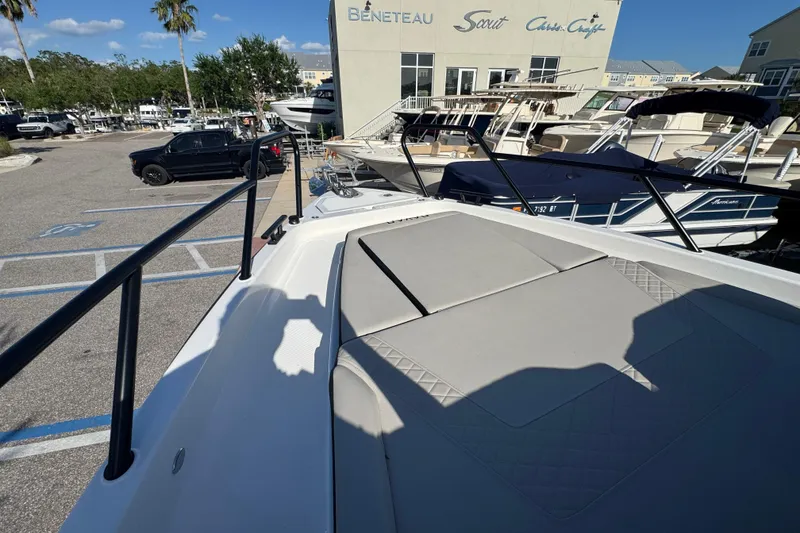 Slide: The Image of Navan S30 boat at marina, 2026 model, with sunpad and surrounding boats. - 16
