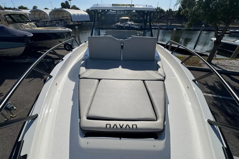 Slide: The Image of 2026 Navan S30 boat with cushioned seating, docked at a marina. - 18