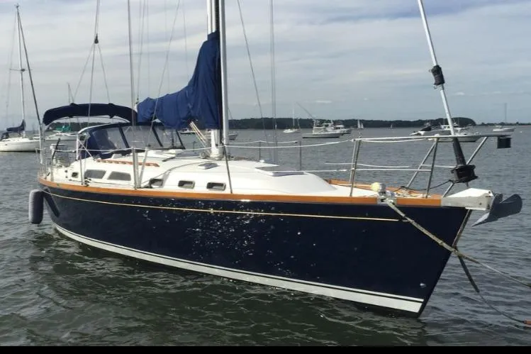 The Image of 2004 Sabre 426 sailboat with blue hull anchored in calm waters. - 0