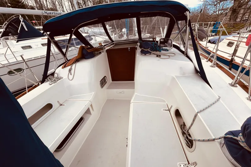 Slide: The Image of 2004 Sabre 426 sailboat cockpit with blue canopy and seating area. - 14