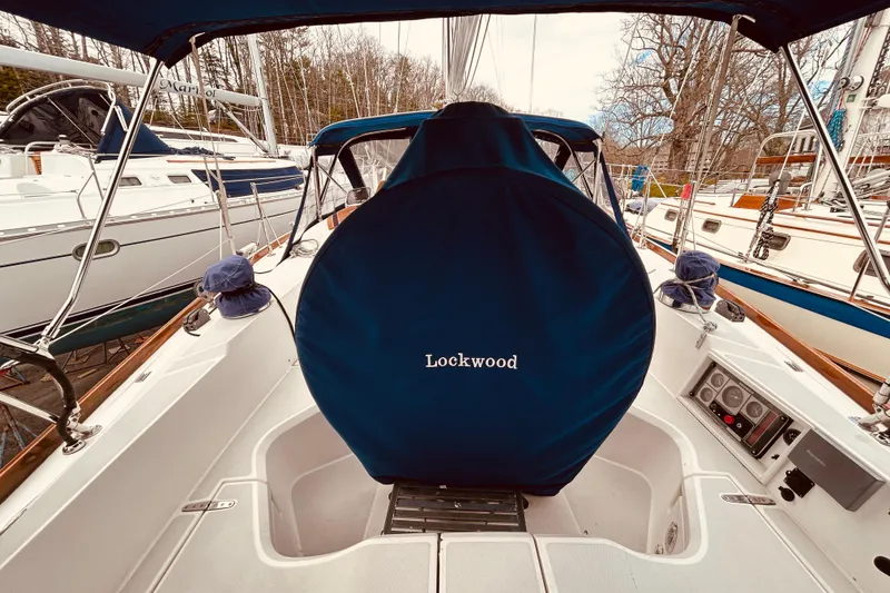 Slide: The Image of Cockpit of a 2004 Sabre 426 sailboat with blue cover and "Lockwood" text. - 15