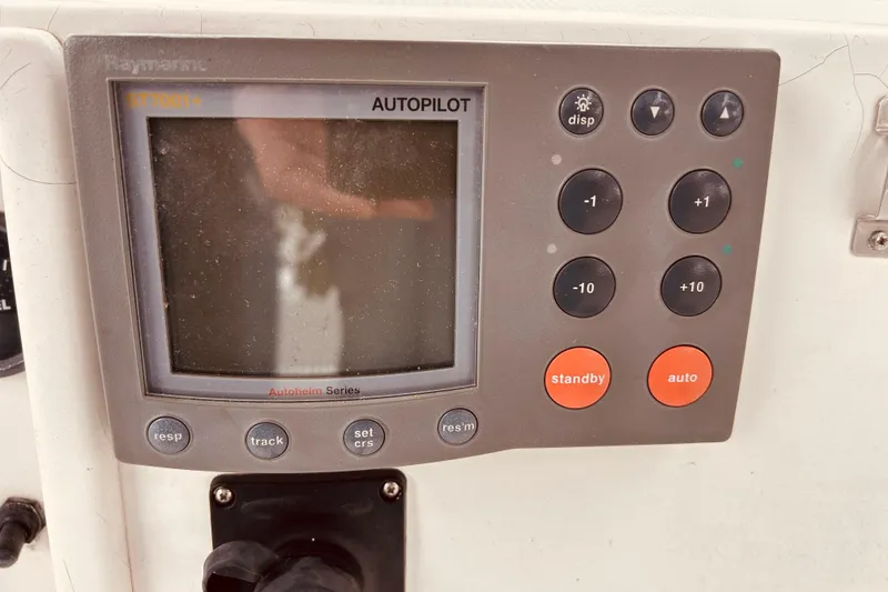 Slide: The Image of Autopilot control panel on a 2004 Sabre 426 yacht, featuring various navigation buttons. - 21