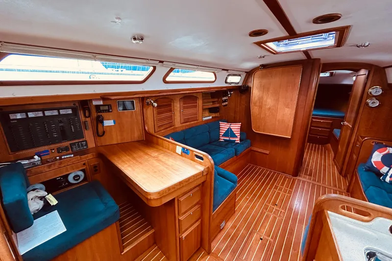 Slide: The Image of Interior of 2004 Sabre 426 sailboat with wooden furnishings and blue seating. - 24