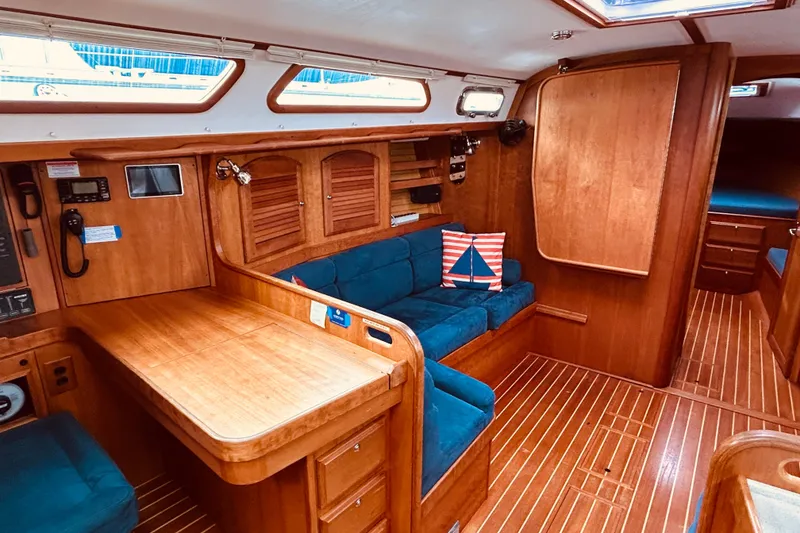 Slide: The Image of Interior of 2004 Sabre 426 yacht with wooden finish and blue seating. - 25