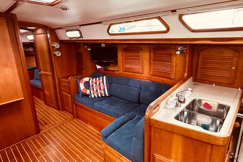 Slide: The Image of Interior of 2004 Sabre 426 yacht with wooden cabinetry and blue seating. - 26