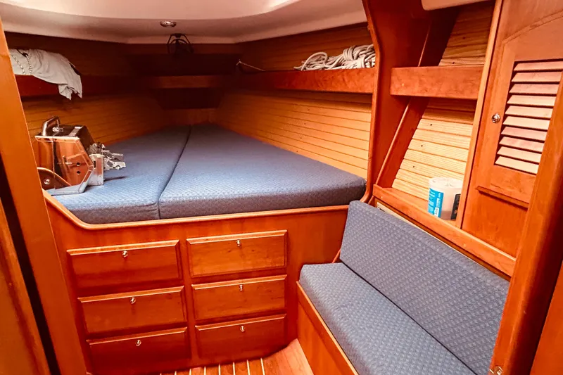 Slide: The Image of Cozy cabin interior of 2004 Sabre 426 sailboat with wooden finish and blue upholstery. - 32