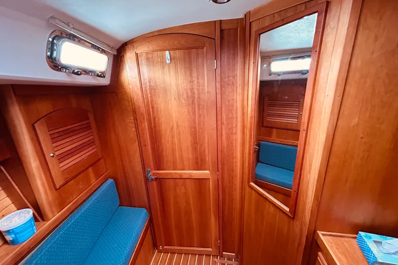 Slide: The Image of Interior of 2004 Sabre 426 sailboat with wooden paneling and blue seating. - 35
