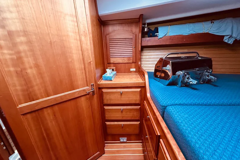 Slide: The Image of Wooden cabin interior of 2004 Sabre 426 yacht with drawers and blue bedding. - 36