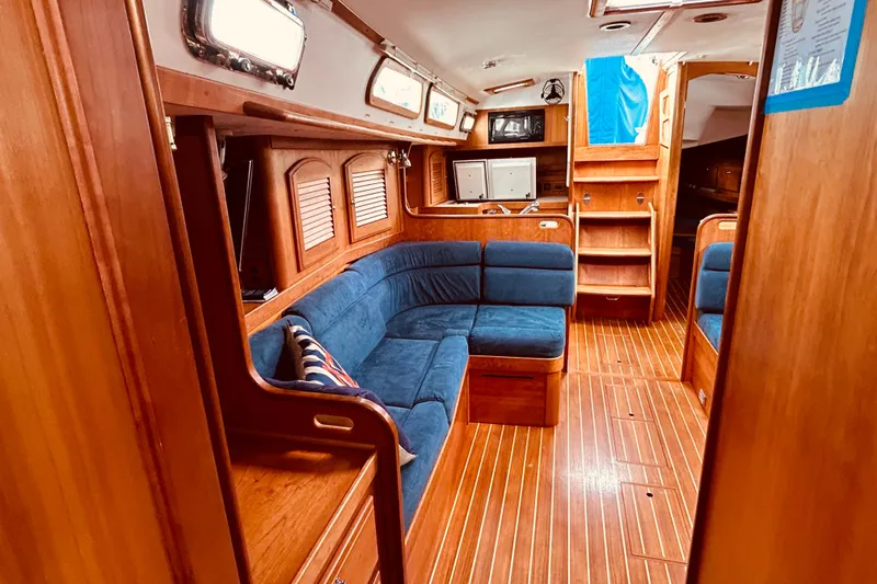 Slide: The Image of Interior of 2004 Sabre 426 yacht with wooden finish and blue seating. - 38