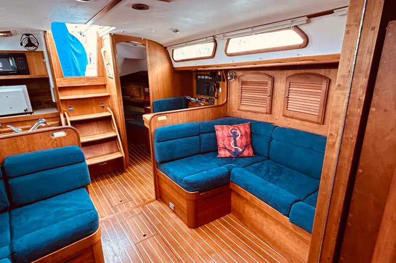 Slide: The Image of Interior of 2004 Sabre 426 yacht with blue seating and wooden finishes. - 39