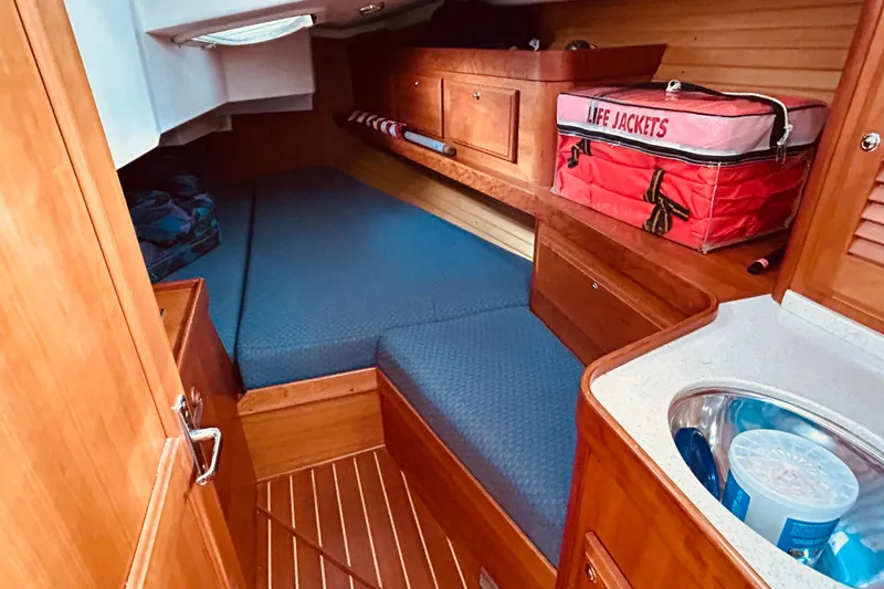 Slide: The Image of Cozy cabin interior of 2004 Sabre 426 sailboat with wooden finish and life jackets. - 41