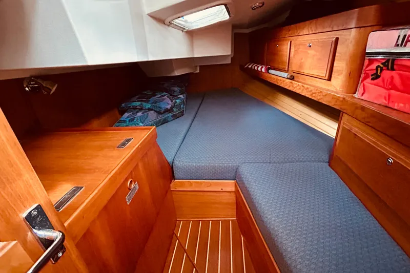 Slide: The Image of Cozy cabin interior of 2004 Sabre 426 sailboat with wooden finish and blue cushions. - 42