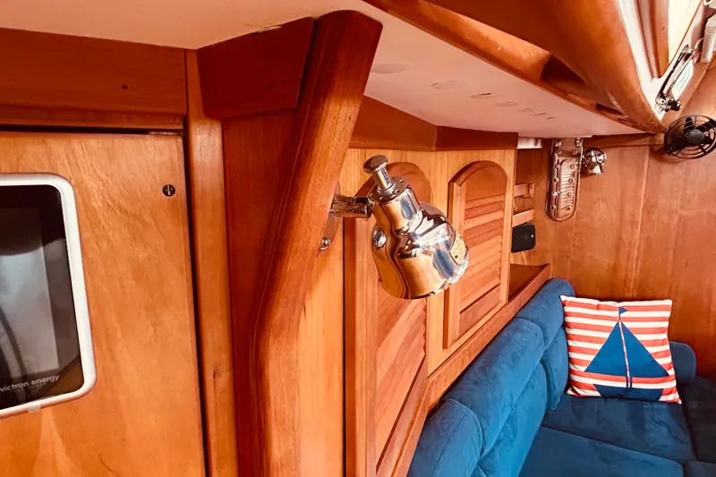 Slide: The Image of Interior of 2004 Sabre 426 yacht with wooden paneling and blue seating. - 43