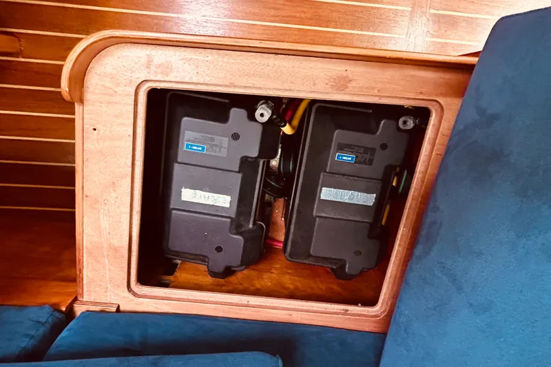 Slide: The Image of Battery compartment in a 2004 Sabre 426 yacht, featuring dual black battery units. - 49