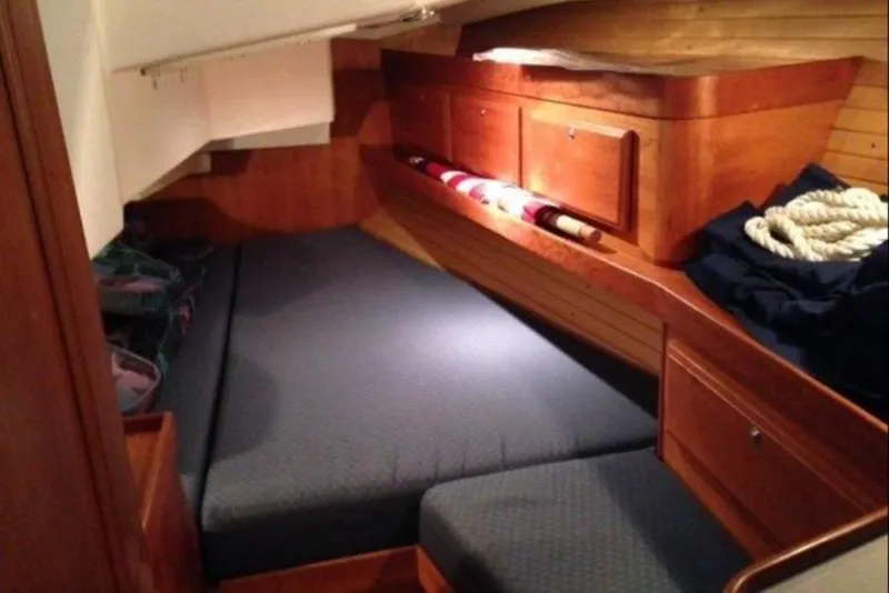 Slide: The Image of Cozy cabin interior of 2004 Sabre 426 sailboat with wooden furnishings and bedding. - 6