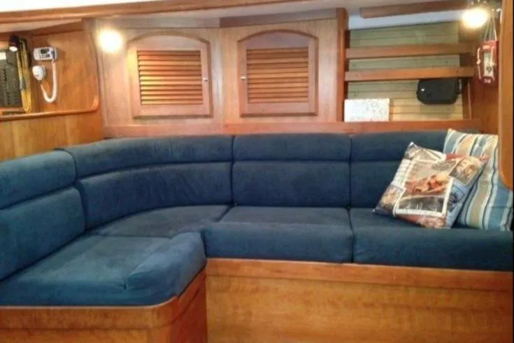 Slide: The Image of Interior of 2004 Sabre 426 yacht with blue cushioned seating and wooden accents. - 7