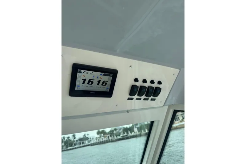 Slide: The Image of 2023 Robalo R272 Center Console dashboard with digital display and control switches. - 13