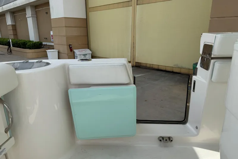 Slide: The Image of 2023 Robalo R272 Center Console boat interior with seating and storage compartments. - 14