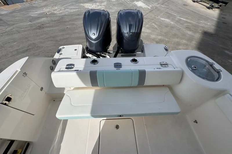 Slide: The Image of 2023 Robalo R272 Center Console boat with dual engines and seating area. - 4