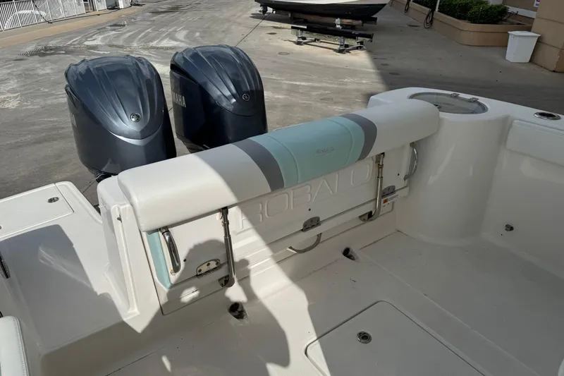 Slide: The Image of 2023 Robalo R272 Center Console boat with dual Yamaha engines, docked outdoors. - 5