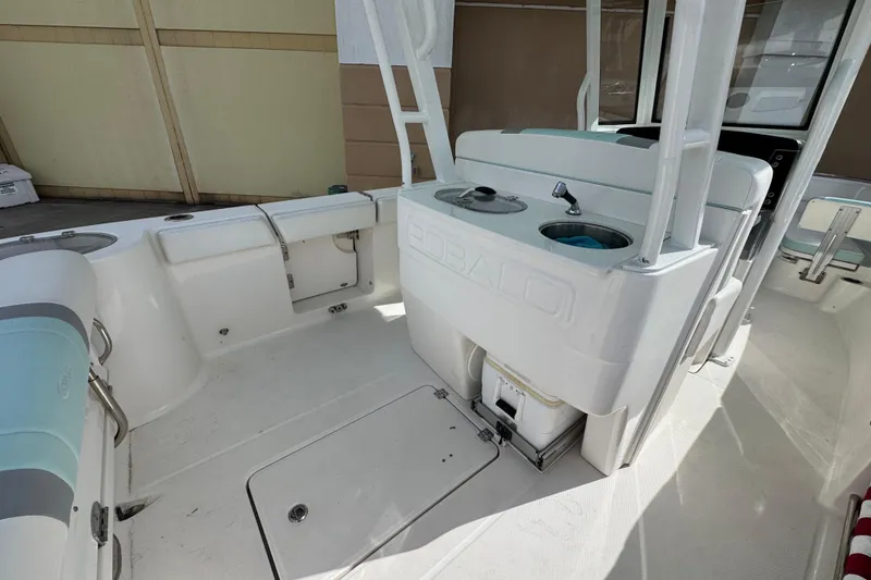 Slide: The Image of 2023 Robalo R272 Center Console boat interior with seating and storage compartments. - 6