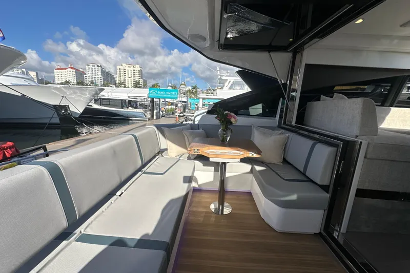 Slide: The Image of Luxurious 2026 Fairline Targa 47 GT yacht interior with elegant seating and table. - 13
