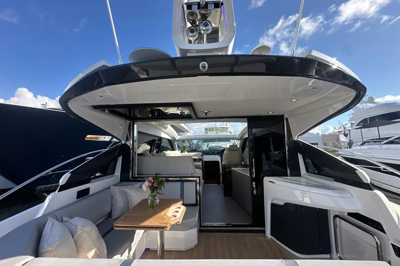 Slide: The Image of Luxurious 2026 Fairline Targa 47 GT yacht interior with elegant seating and table. - 14