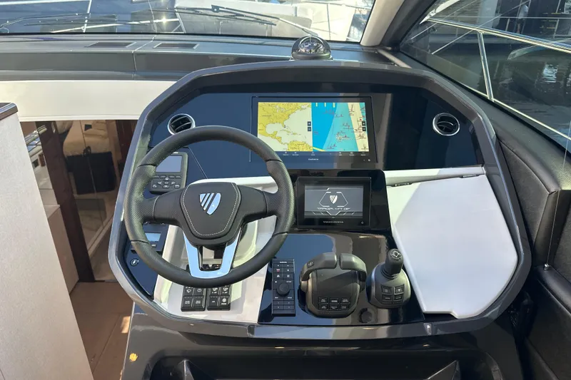Slide: The Image of 2026 Fairline Targa 47 GT helm with navigation display and controls. - 23