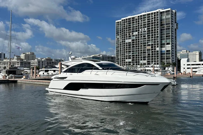 Slide: The Image of 2026 Fairline Targa 47 GT yacht docked in urban marina, modern cityscape background. - 4