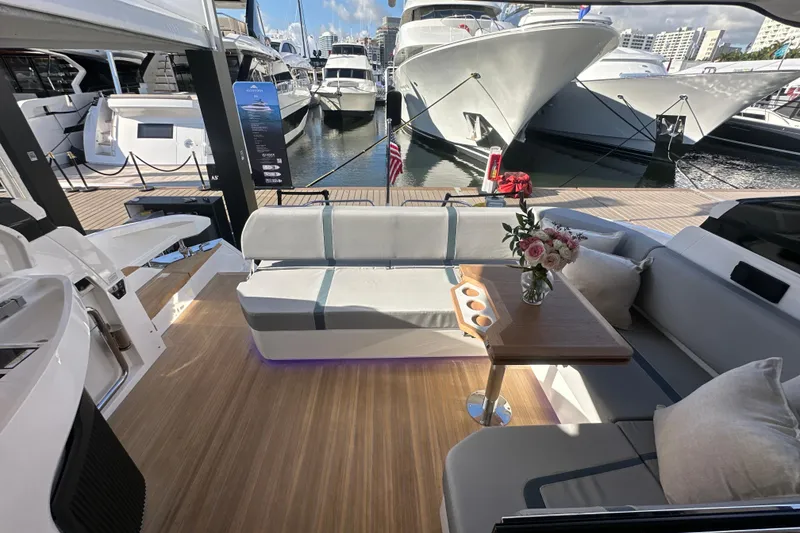Slide: The Image of Luxurious Fairline Targa 47 GT yacht interior, featuring elegant seating and a wooden table with flowers. - 48