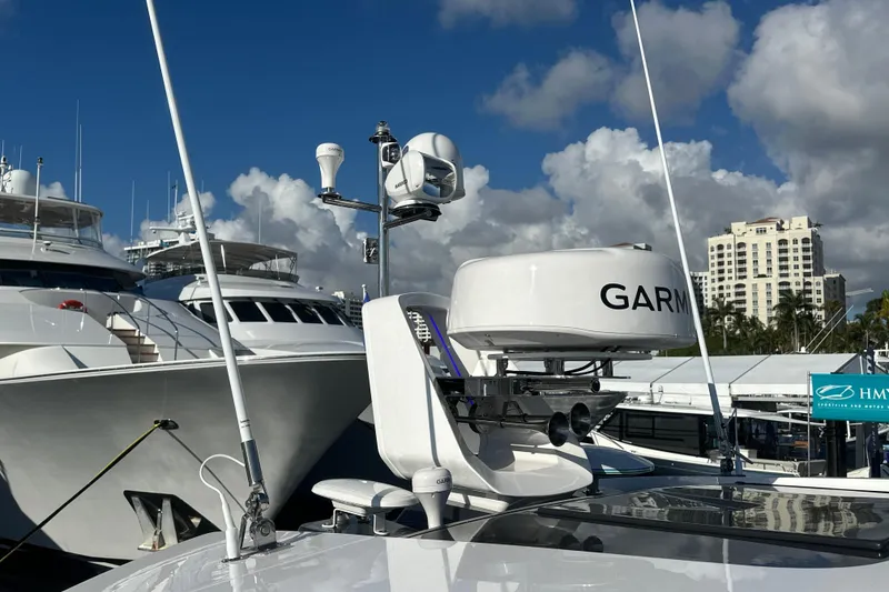 Slide: The Image of 2026 Fairline Targa 47 GT yacht with Garmin radar, docked under a blue sky. - 50