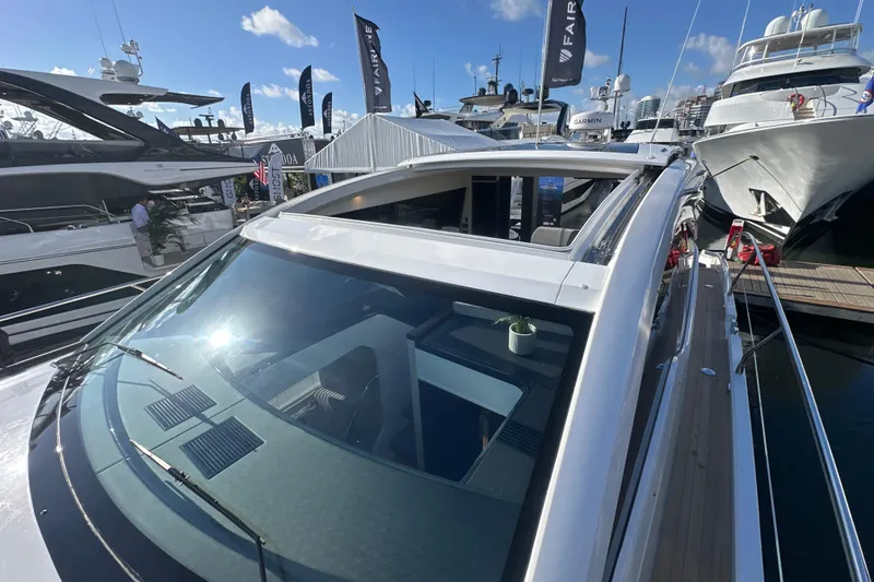 Slide: The Image of 2026 Fairline Targa 47 GT yacht at marina, showcasing sleek design and open sunroof. - 55