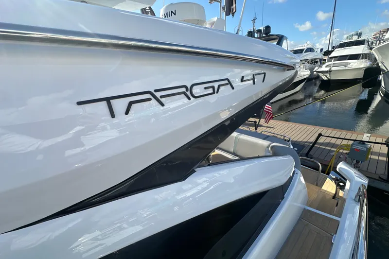 Slide: The Image of 2026 Fairline Targa 47 GT yacht docked at marina, showcasing sleek design. - 57