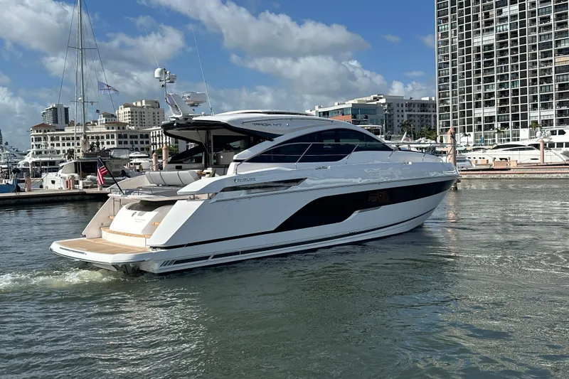 Slide: The Image of 2026 Fairline Targa 47 GT yacht docked in a marina, with cityscape background. - 6