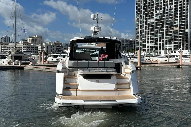 Slide: The Image of 2026 Fairline Targa 47 GT yacht docked in a marina, cityscape background. - 7