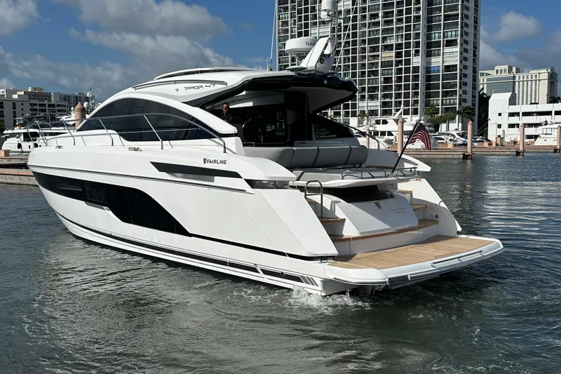Slide: The Image of Luxury Fairline Targa 47 GT yacht, 2026 model, docked in a marina with cityscape backdrop. - 8