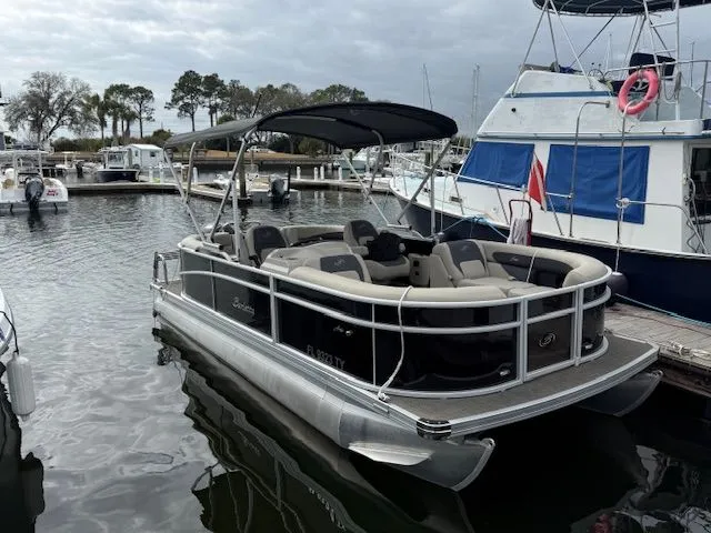 Slide: The Image of 2024 Barletta Aria pontoon boat docked at marina. - 24