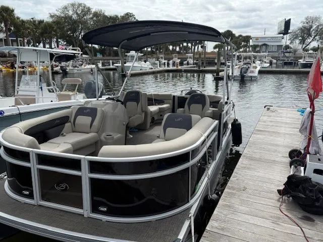 Slide: The Image of 2024 Barletta Aria pontoon boat docked at marina. - 25
