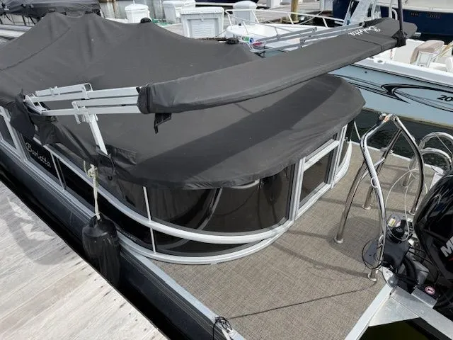 Slide: The Image of 2024 Barletta Aria pontoon boat docked with cover. - 5