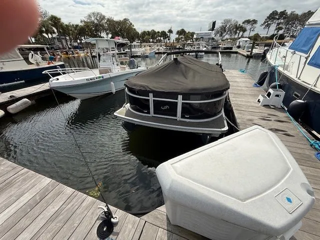 Slide: The Image of 2024 Barletta Aria pontoon boat docked at marina. - 8