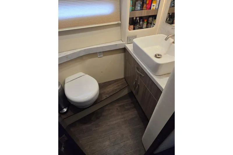 Slide: The Image of Bathroom interior of 2021 Regal 38 Grande Coupe yacht, featuring modern sink and toilet. - 11