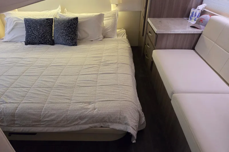 Slide: The Image of Luxurious bedroom interior of 2021 Regal 38 Grande Coupe yacht with cozy bedding. - 13