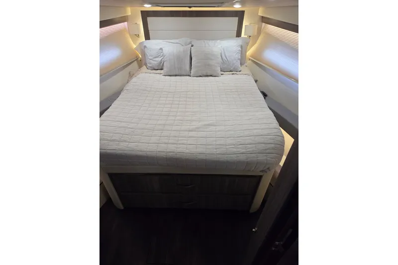 Slide: The Image of Interior cabin of 2021 Regal 38 Grande Coupe with cozy bed and pillows. - 15