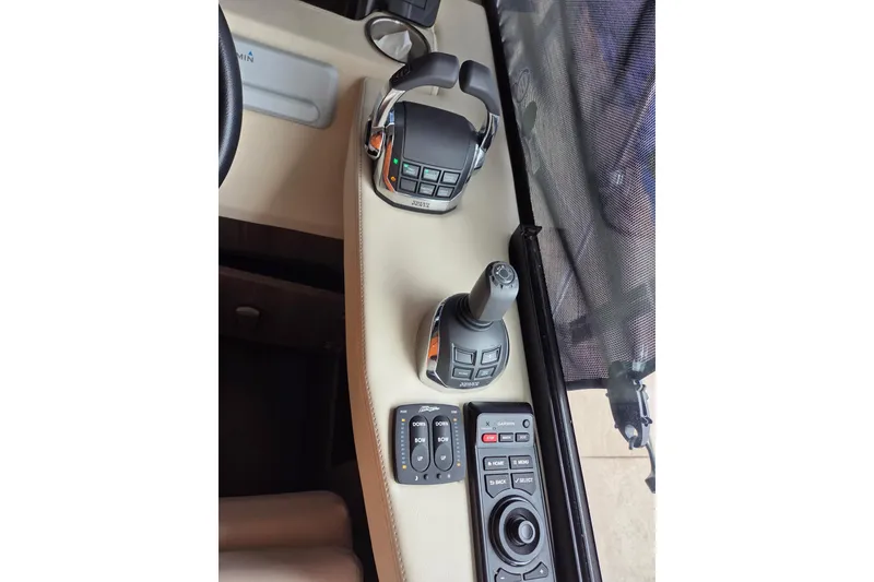 Slide: The Image of Control panel of a 2021 Regal 38 Grande Coupe boat with joystick and buttons. - 8